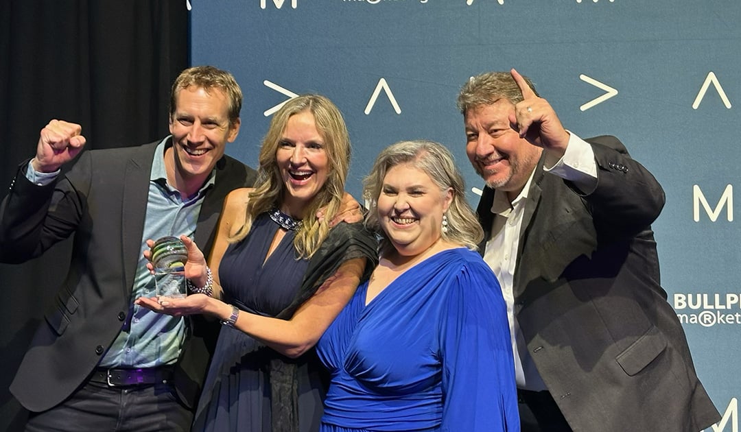 Fifth Ring employees accepting the AMA Crystal Awards trophy