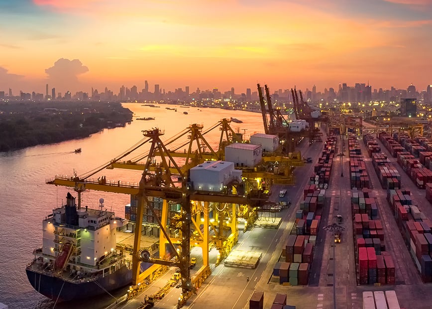 photo of heavy industrial landscape by a river at sunset