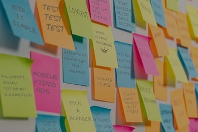 Post it notes on whiteboard showing marketing phrases